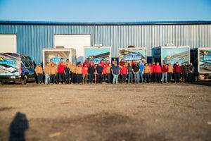 JR Insulation team in front of shop and trucks