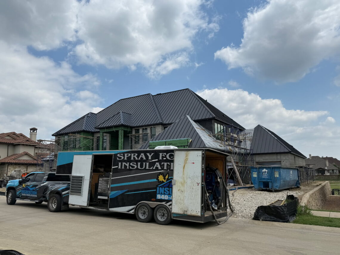 JR Insulation truck and rig in front of a custom home job